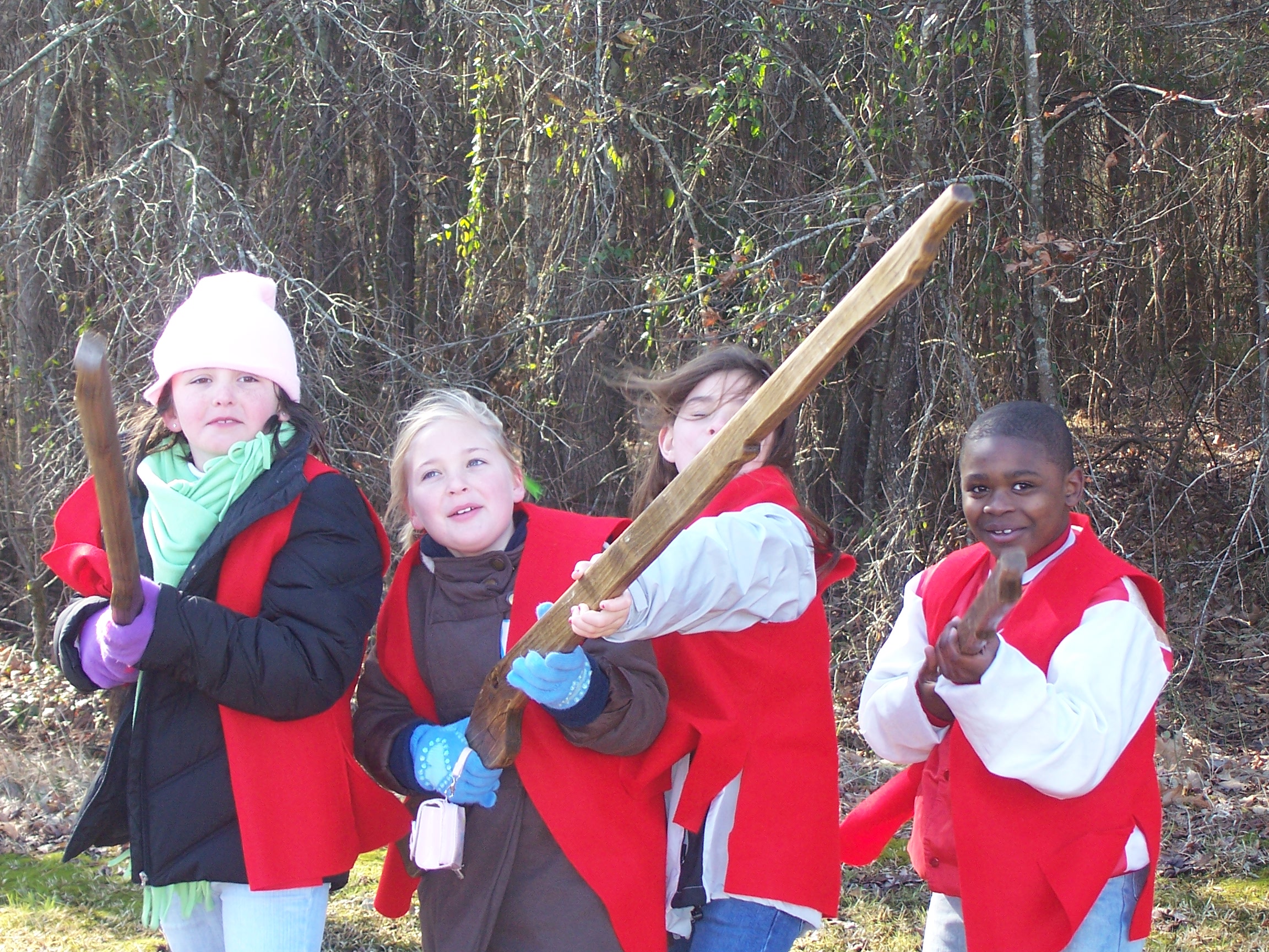 Students re-enact defending Fort Watson in their red vests.